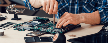Personne réparant un ordinateur portable avec des outils