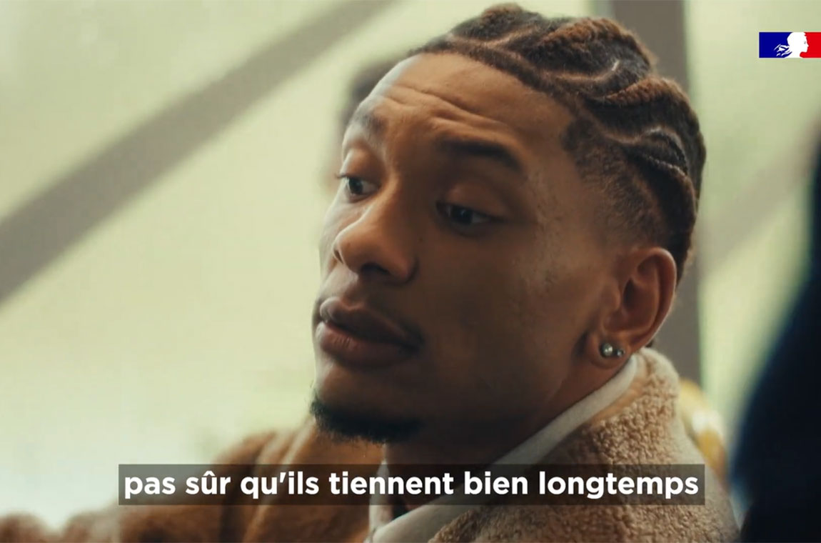 Personne portant un sweat beige avec fermeture éclair assise dans un environnement intérieur